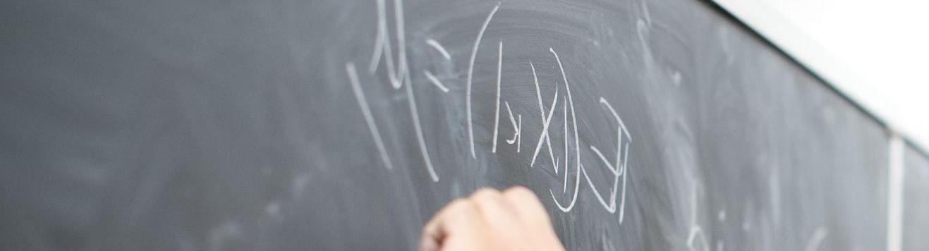 Temple faculty member using board to explain complex math problem